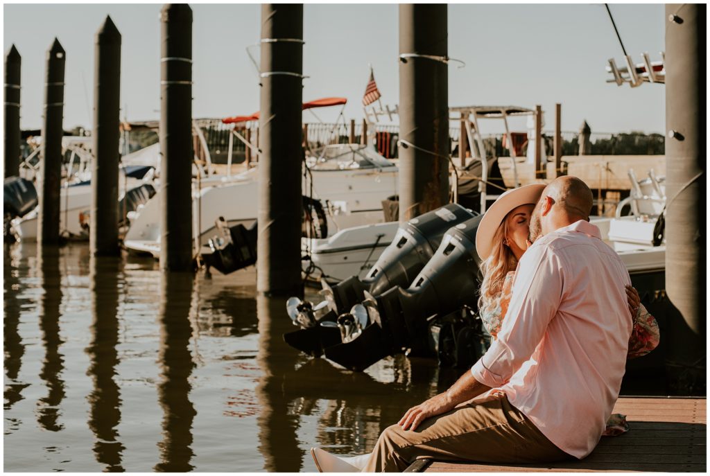 Couple kissing surrounded by boats